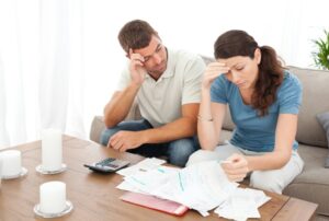 protect your credit from divorce. Couple reviewing finances.